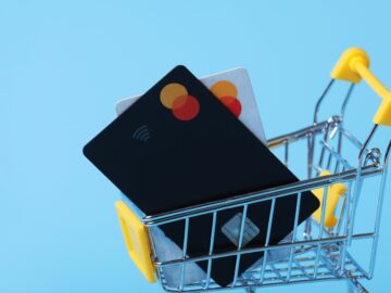 1,000+ web shops infected by “Phish ‘n Ships” criminals who create fake product listings for in-demand products A tiny shopping cart carries two credit cards. It rests in front of a light blue background.