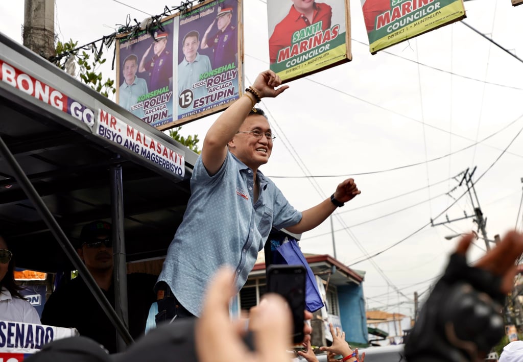 Senator Bong Go (centre) gestures during a motorcade in Manila, the Philippines, on May 7. He is among the 15 candidates named in the complaint. Photo: EPA-EFE
