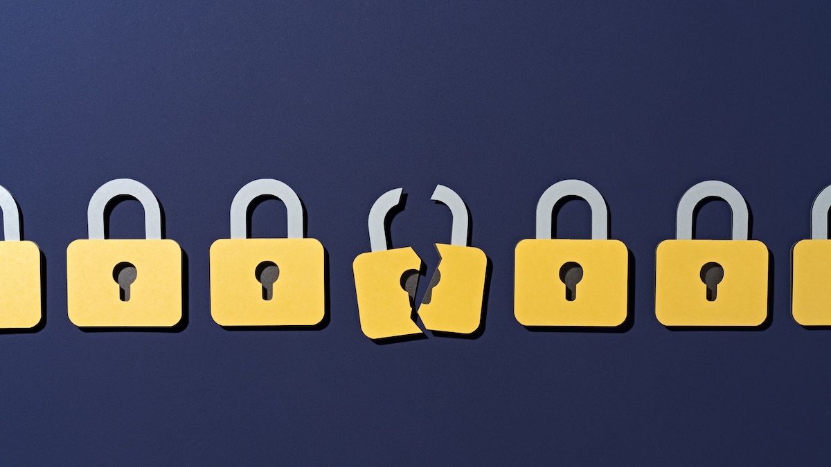 Several locks presented in a row, with the lock in the middle broken in half