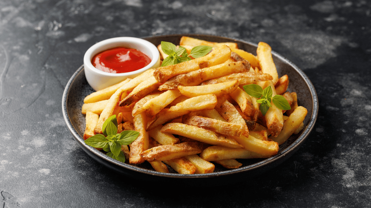 A plate of fries and ketchup