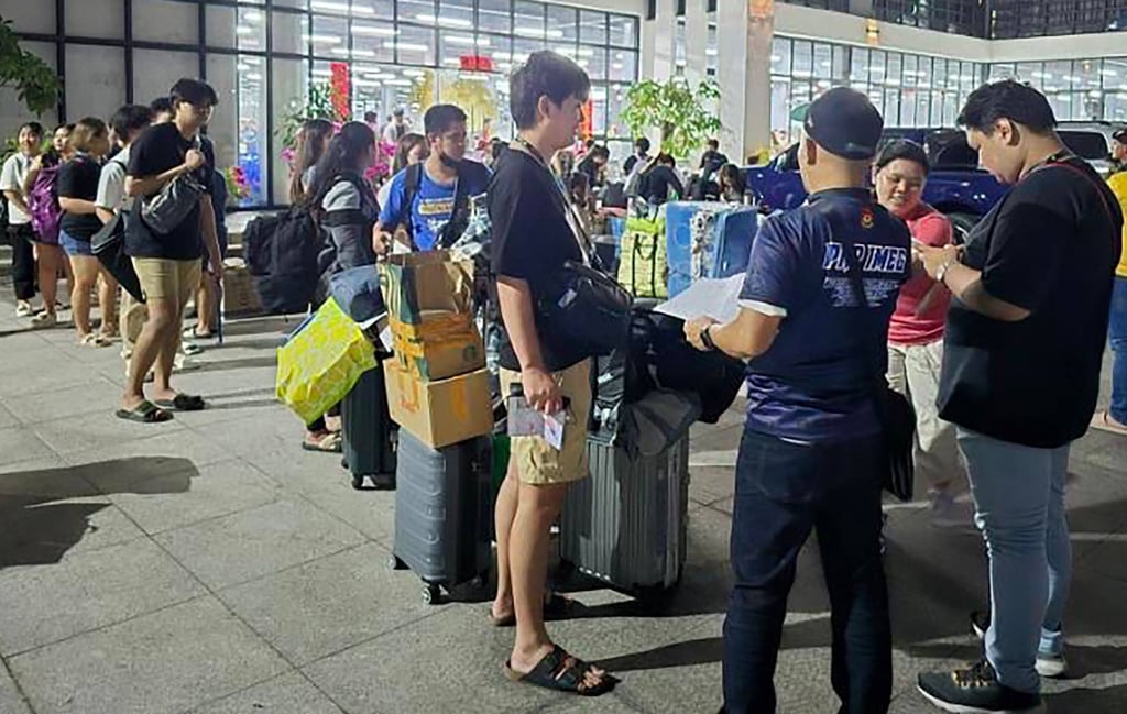 Ex-Pogo workers fuel rise in Philippine online scams, police say A police officer (front, centre) talking to foreign nationals after a raid in a scam centre within a complex of buildings in Bamban town of Tarlac province in March last year. Photo: PAOCC/AFP