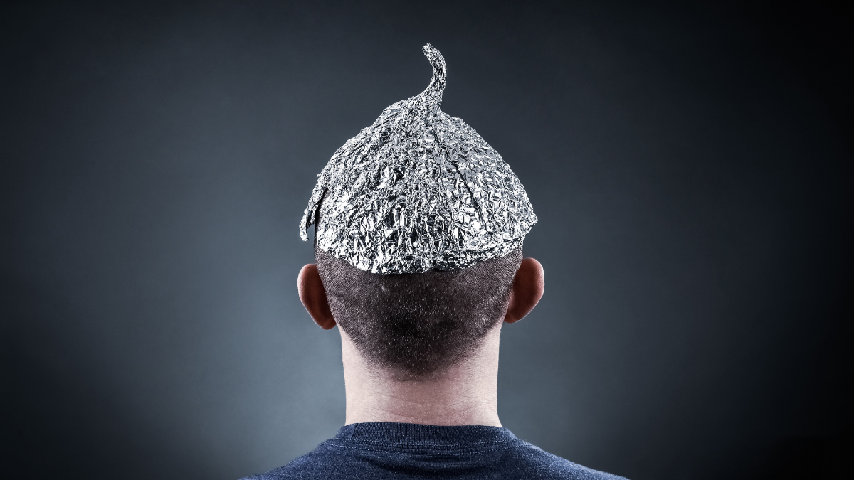 A man facing away from the camera wearing a tin foil hat