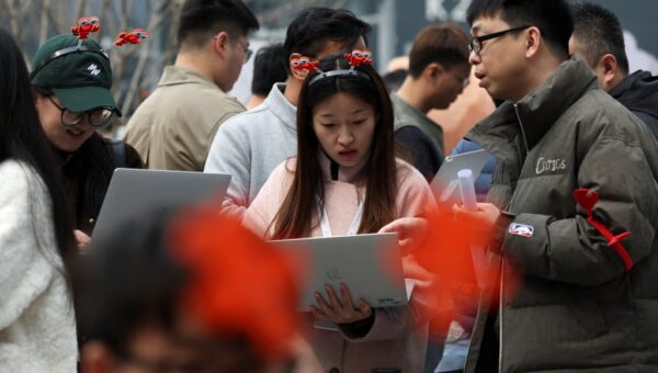 People queue to have OpenClaw installed outside the Baidu offices in Beijing on March 17. Photo: Reuters