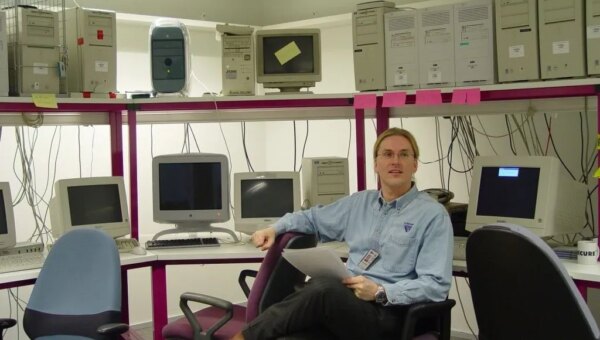 a younger Mikko Hyppönen surrounded by computers.