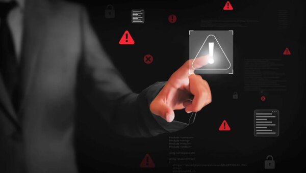 Hand pointing at a cybersecurity symbol