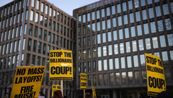 Demonstrators gather outside of the Office of Personnel Management in Washington, D.C. on February 7, 2025 to protest federal layoffs and demand the termination of Elon Musk from the Department of Government Efficiency (DOGE). (Photo by Bryan Dozier / Middle East Images / Middle East Images via AFP)