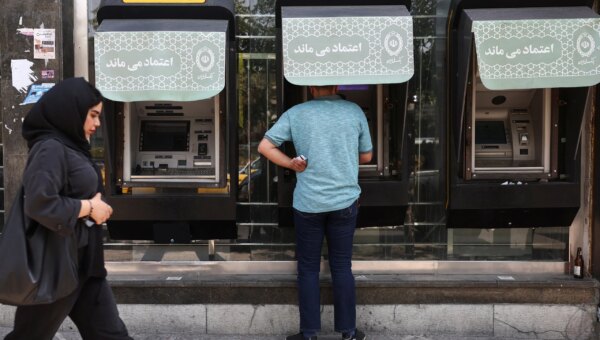A Bank Melli customer uses a cash dispenser in Tehran. Bank Melli was one of the banks hit in this week's cyberattack