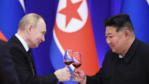 Russian President Vladimir Putin and North Korean leader Kim Jong Un toast.