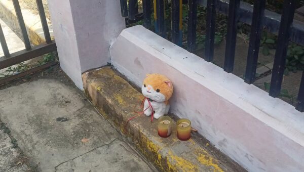 Candles and a stuffed toy are left outside Ateneo de Zamboanga University on August 19, a day after a shooting that killed two people in Zamboanga, southern Philippines. Photo: Reuters