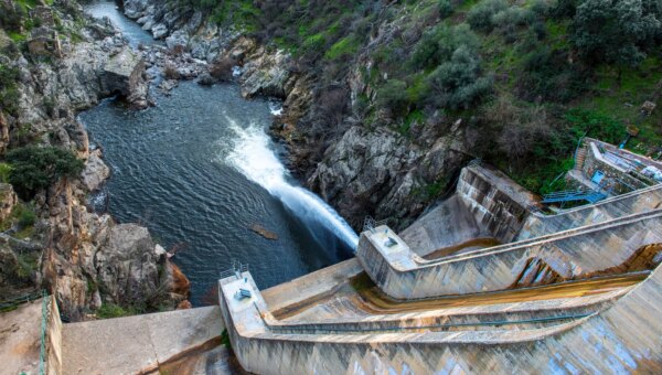 a photo of a dam in Spain seen spilling water.