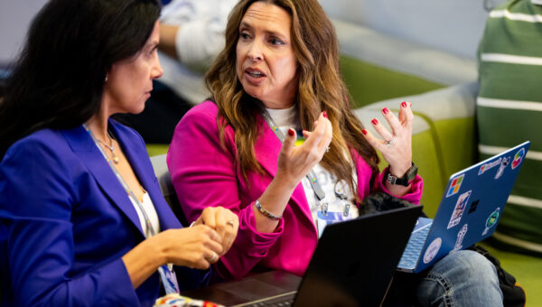Two women networking at Microsoft Ignite 2025.